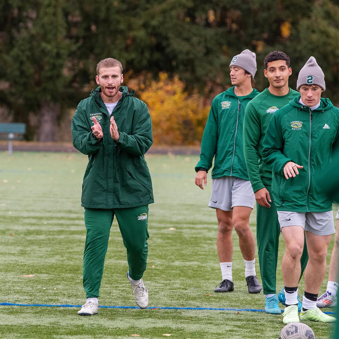 Owen+Brady+%2725+cheering+on+Skidmore+men%27s+soccer+players+at+practice.+